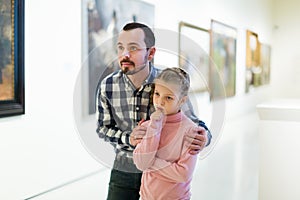 Father and daughter looking at expositions