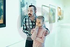 Father and daughter looking at expositions