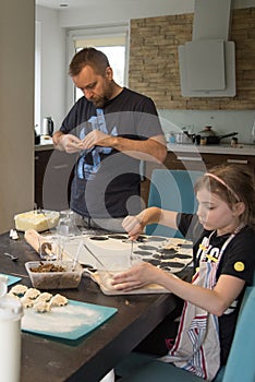 Father and daughter making a dough