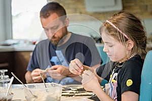 Father and daughter making a dough