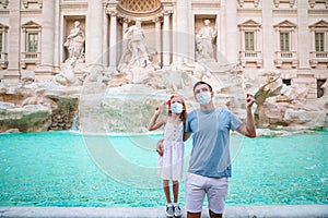 Father and daughter near fountain Fontana di Trevi with coins in hands