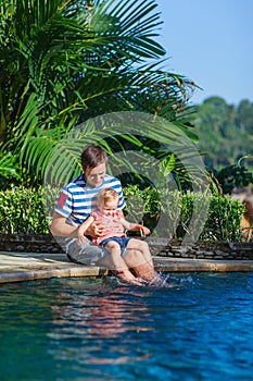 Father and daughter near swimming pool