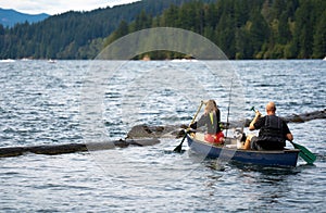 Father and daughter with oars went fishing with husky dog rowing in kayak on the waves of Lake Merwin in Washington