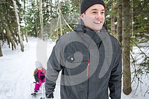 Father and daughter outdoor in the winter forest