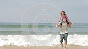 Father And Daughter Playing On Beach