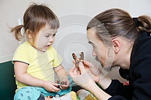 Father and daughter playing, dad teaching child chess figure