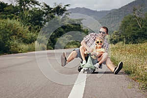 Father and daughter playing  on the road at the day time