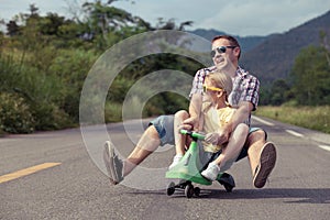 Father and daughter playing  on the road at the day time