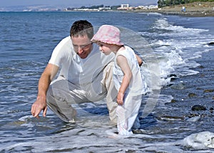 Father and Daughter playing in the sea