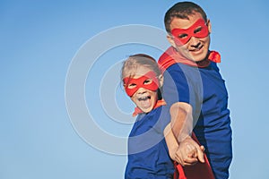 Father and daughter playing superhero at the day time.