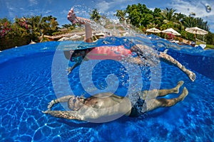 Father and daughter playing in a swimming pool