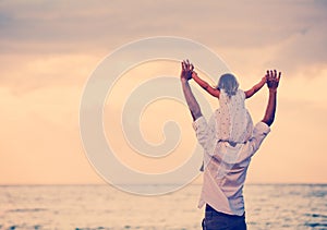 Father and Daughter Playing Together at the Beach at Sunset