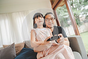 father and daughter playing video game