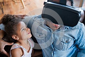 Father and daughter playing video games. photo