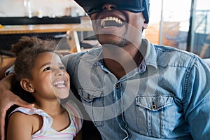 Father and daughter playing video games. photo