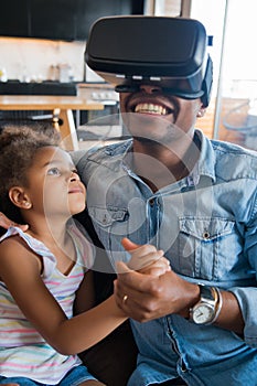 Father and daughter playing video games. photo