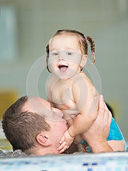 Father and daughter in a pool