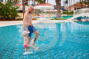 Father and daughter in the pool