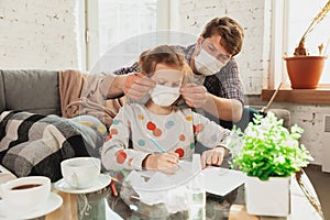 Father and daughter in protective masks and gloves isolated at home with coronavirus symptoms, stop epidemic