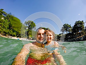 Father and daughter selfie in sea