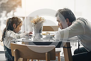 Father and daughter sit and rest after eating at family time