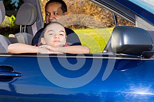 Father And Daughter Sitting In Mini Van