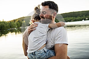 Father and daughter solace on the pier warm summer day h