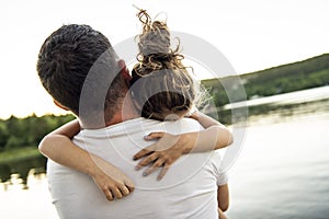 Father and daughter solace on the pier warm summer day h