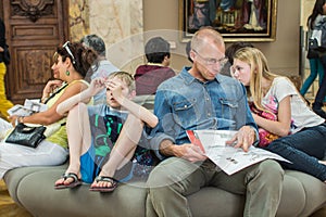 Father, daughter, and son rest in Louvre, Paris, France