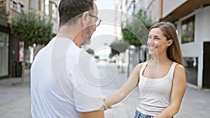 Father and daughter, standing together on a sunny city street, looking into each other\'s eyes, smiling with confidence, and