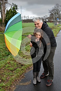 Father and daughter in stormy weather