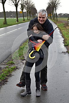 Father and daughter in stormy weather