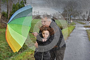 Father and daughter in stormy weather