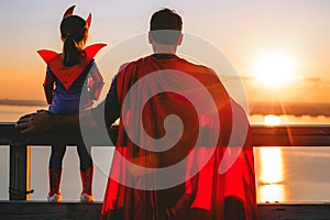 Father and daughter in superhero costume, concept of father love