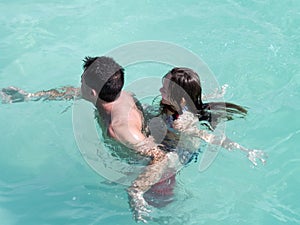 Father and daughter swimming