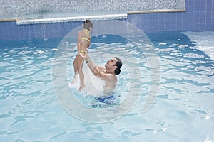 Father and daughter in the swimming pool