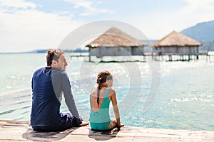 Father and daughter at swimming pool