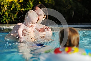 Father and daughter swimming in pool