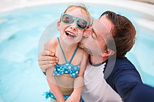 Father and daughter at swimming pool