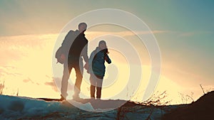 Father and daughter teamwork happy family tourists silhouette concept navigation . team dad and daughter on top of a