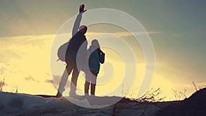 Father and daughter teamwork happy family tourists silhouette concept navigation . team dad and daughter on top of a