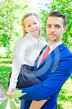 Father with daughter to school. Adorable little girl feeling very excited about going back to school