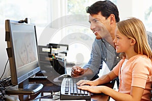 Father and daughter using skype in home office