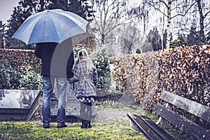 Father and daughter visiting grave