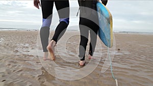 Father and Daughter Walking to the Sea to go Body Boarding