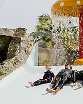 Father and daughter on a water slide in the water park