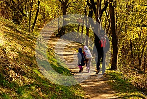 father and daughters on walking in autumn weather