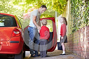 Father Driving To School With Children