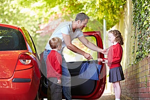 Father Driving To School With Children