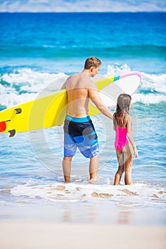 Father and Duagher on the Beach Going Surfing